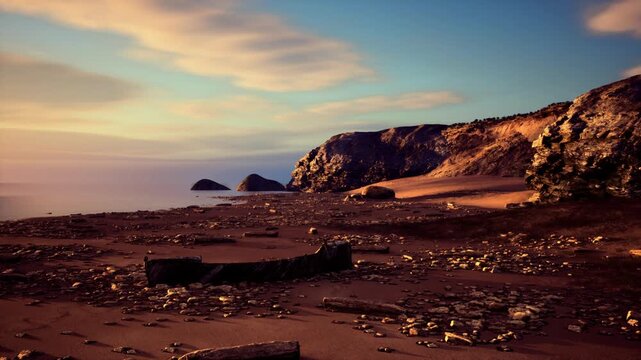 sunset cliffs beach warm golden hues, long shadows over pebbled sand and calm sea under pastel sky, distant rock stacks on horizon, tranquil evening atmosphere