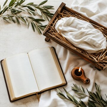 Open Bible beside empty manger with olive branches and burning oil lamp
