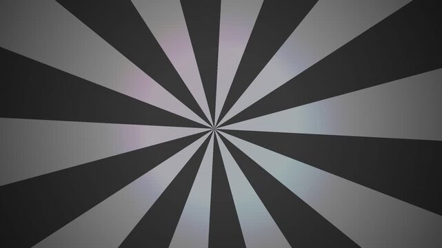 A hypnotic pattern features alternating grey and charcoal segments radiating from the center point to create a sense of depth and rotational energy throughout the entire area of the frame