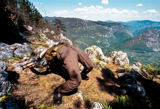 Zepa, Republika Srpska, Bosnia and Herzegovina - May 1993: View of a soldier of the Army of Republika Srpska VRS on a mountain position above Zepa during the Bosnian War.