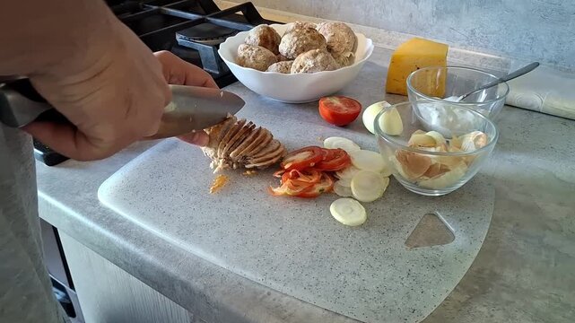 Cooking meatballs with fresh vegetables in a kitchen setting