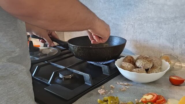 Cooking meat on the stove with vegetables in a kitchen setting