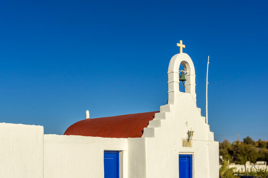Mykonos chapel with white walls and blue sky
