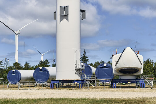 Thisted, Denmark - 11 August 2026: View of disassembled Vestas V-164 9.5 MW wind turbine components at the Wind Test Centre Osterild, with large blades and tower sections on blue support frames.