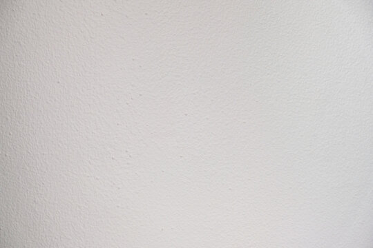 Close-up of white painted wall texture with subtle surface details