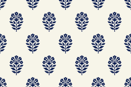 Indian block print seamless pattern with small ikat floral motifs arranged in neat grid on warm cream background traditional hand carved woodblock textile design.