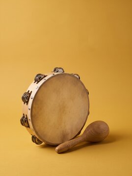 Tambourine and maraca on yellow