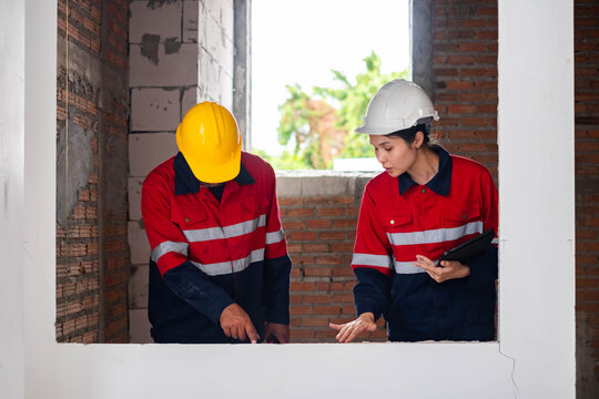 Construction engineers inspecting interior building work at an unfinished house, reviewing structural quality, safety compliance, and renovation progress for professional residential construction.