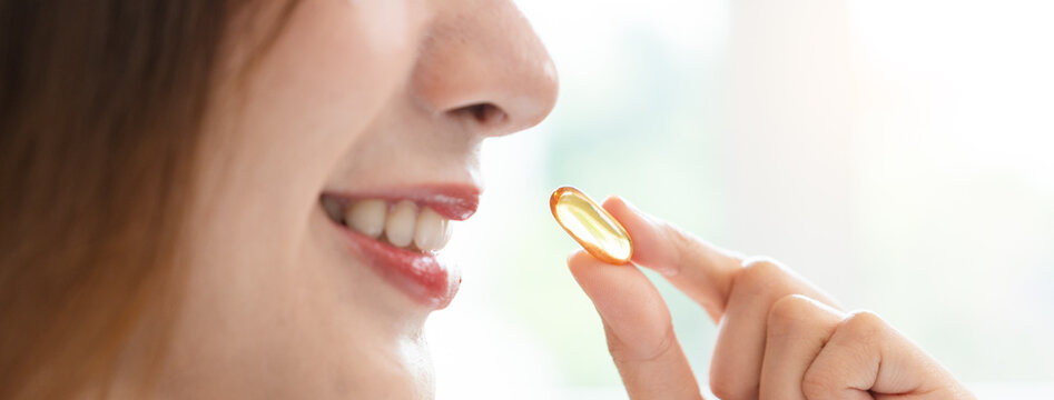 Nourishing the Body, Embracing Wellness: A Person Taking Fish Oil Supplements for Optimal Health and Vitality