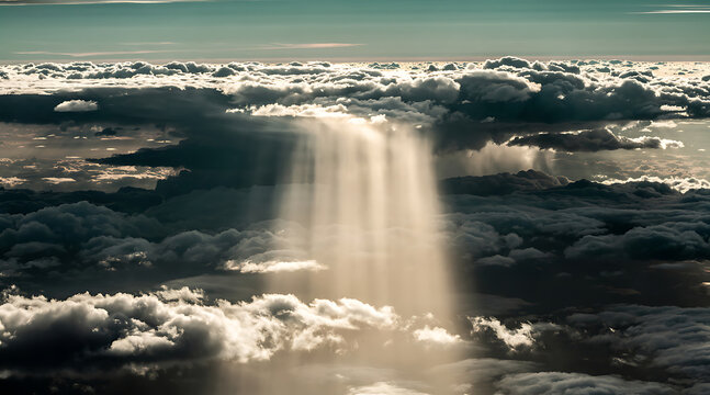 dramatic cloudscape with sun rays piercing through dense clouds above an aerial view of the sky