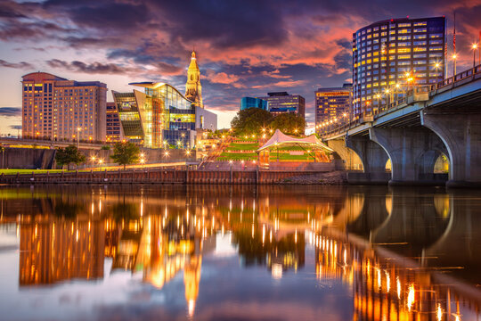 Hartford, Connecticut, USA. Cityscape image of Hartford, capital city of Connecticut with reflection of the city skyline in the water at beautiful sunset.