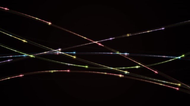 Colorful light trails cross in an x pattern against a dark background