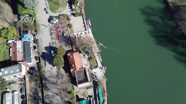 Aerial drone view over Po River and Turin city skyline featuring historic center and the iconic Mole Antonelliana with snowy Alps, Italy