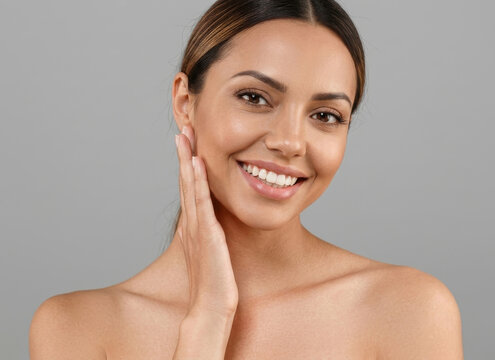 Beautiful woman touching her face with a healthy smile