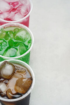 Soft drinks and fruit juice mixed with soda high in sugar have a negative effect on physical health. vertical.	