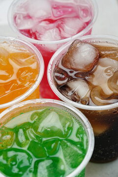 Soft drinks and fruit juice mixed with soda high in sugar have a negative effect on physical health. vertical.	