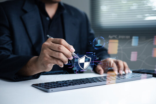 Business professional performs digital identity verification and security checks with a virtual shield interface, representing KYC, biometric authentication, data protection and secure access.