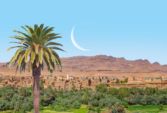 Old kasbah in Tinerhir, typical Moroccan town beside an oasis in Dades Valley - Ancient Berber village, lush green oasis in valley surrounded by the Atlas - Mountains - Tinghir, Morocco