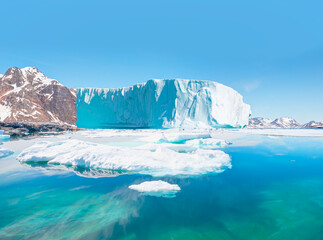 Melting icebergs by the coast of Greenland, on a beautiful summer day - Melting of a iceberg and pouring water into the sea - Greenland © muratart