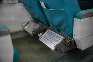 Blue train seats with foldable footrests. The cabin interior features soft color tones and a functional design. Ideal for a travel theme. © Daniel Pawer