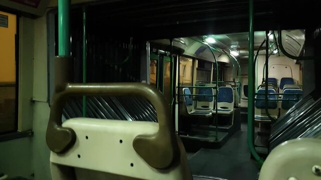 The interior of a bus in the evening, at night, while in motion. An empty bus interior. Public transportation, a bus.