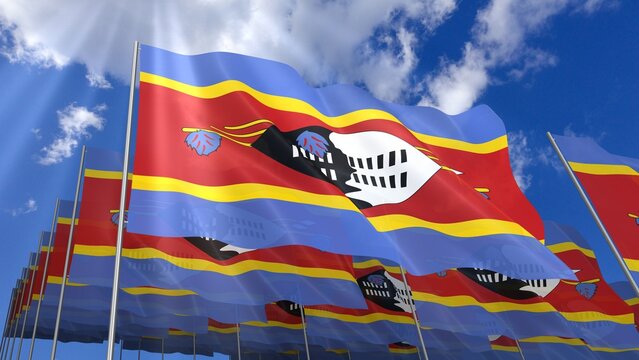 Multiple Eswatini flags waving on blue sky