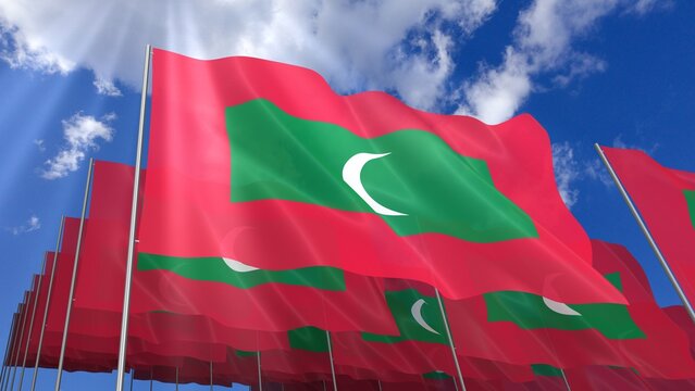 Multiple Maldives flags waving on blue sky