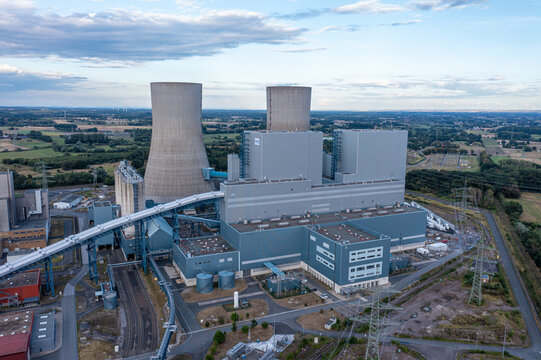 Aerial view of the RWE Westfalen power plant with its distinctive cooling towers, industrial buildings, and surrounding landscape in Hamm, Nordrhein-Westfalen, Germany.