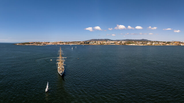 Aerial view of the tall ship NRP Sagres sailing in the Atlantic Ocean near the coastline of Cascais, Lisbon, Portugal.