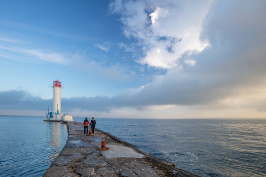 Couple on the Pier near the Old Lighthouse