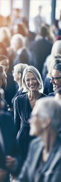 Smiling attendees enjoy casual networking and conversation at a business event, showing positive social connection and approachable professional personality.