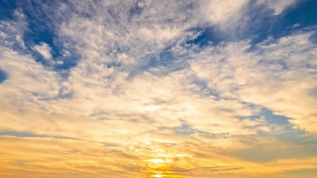 Beautiful blue and orange sunset sky with soft wispy clouds background