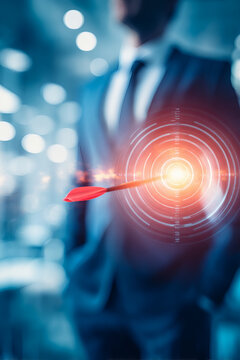 studio style image showing a suited figure softly blurred in the background holding a luminous golden target with concentric labeled rings. A red and black dart is precisely aligned into the 