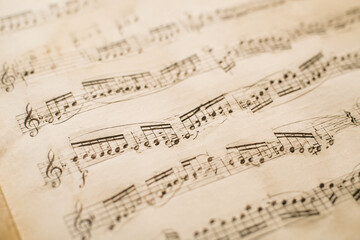 Fototapeta premium Classical music manuscript with flowing notes on aged paper.
