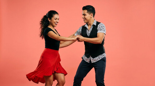 Young couple performing salsa dance together in vibrant studio  