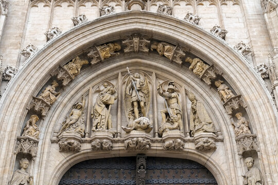 Ornate carved stone archway with religious figures, Belgium