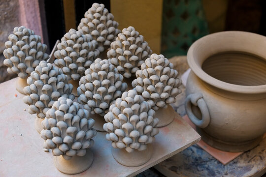 Clay pinecone decorations waiting to be fired