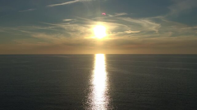 Golden sun setting over the Baltic Sea horizon