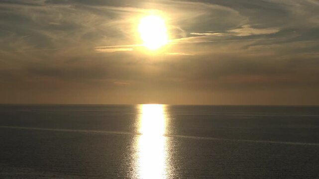 Golden sun setting over the calm Baltic Sea horizon