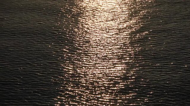 Golden sunlight glittering and reflecting on water