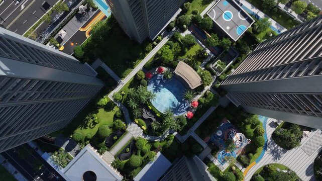 Aerial view of modern residential complex with swimming pool and greenery