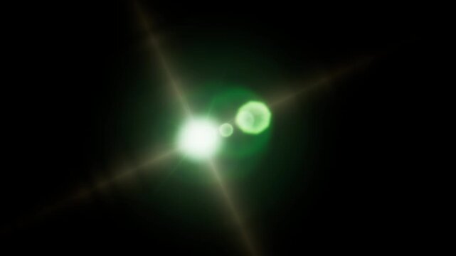 Bright glowing light source creating a realistic green lens flare effect on black background