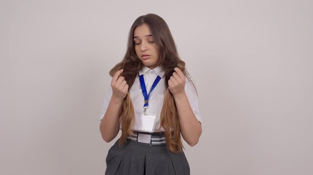 Schoolgirl Checking Dry and Damaged Hair Split Ends