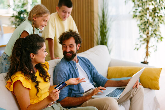 Happy family discussing online shopping and household finances at home