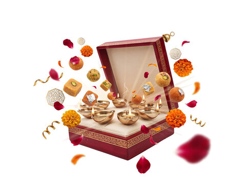 Luxury Indian festive sweet box with lit brass diyas, floating laddus, and marigold flowers