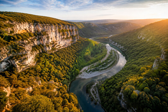 Aerial view of lush green river winding through limestone gorge in France.