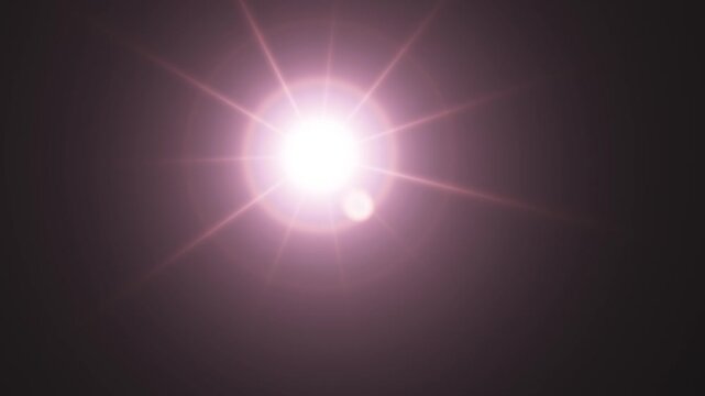 Bright realistic lens flare effect with vibrant rays against a dark background.