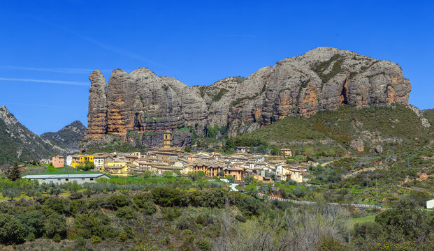Aguero village in Aragon, Spain, panoramic view with Los Mallos mountains behind. Traditional stone houses and rock landscape