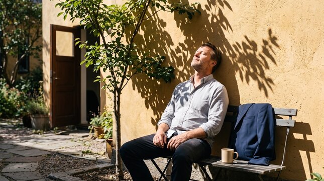 Office worker sits alone on a bench during a brief sun break