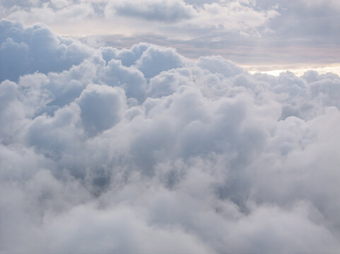 Aerial view of dense white cumulus clouds filling the frame, illuminated by soft sunlight from above France.